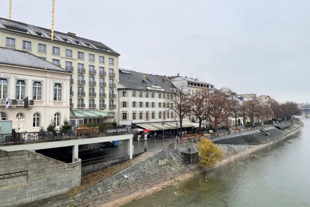 A row of multi-story hotels along the banks of the Rhine River in Basel, Switzerland.