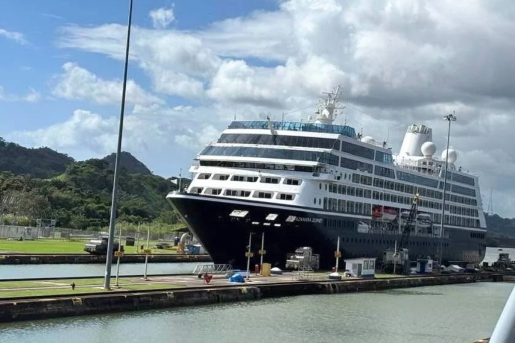 Azamara Journey cruise ship inside a Miraflores lock chamber with green hills behind it