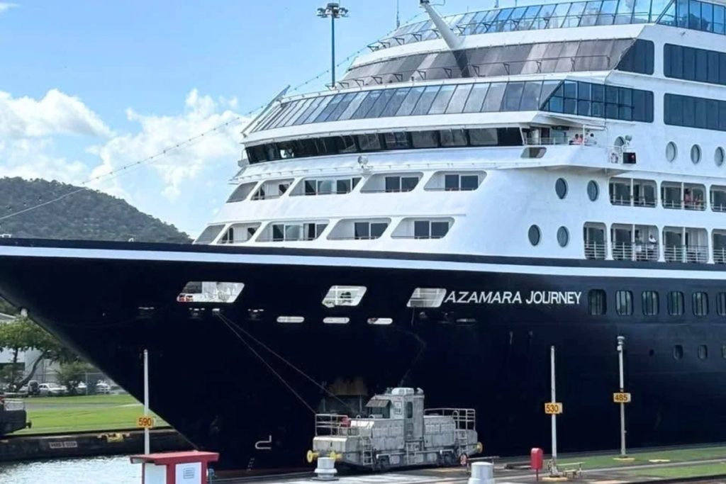 Close view of the Azamara Journey bow with an electric mule locomotive on the lock wall beside it