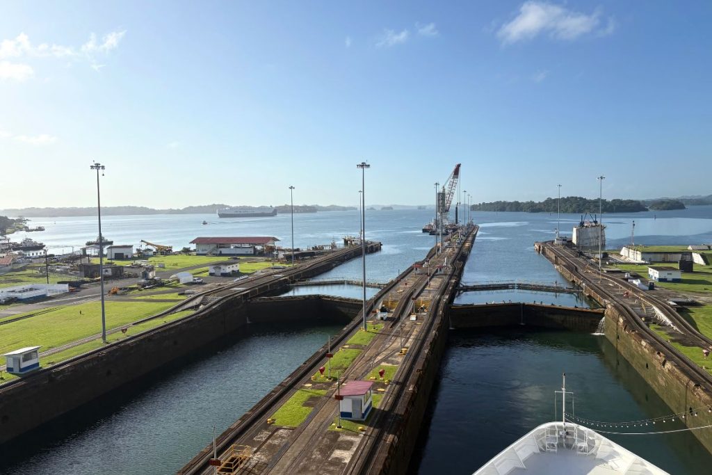 Ship bow in a Gatun lock chamber facing closed gates while sailing through the Panama Canal