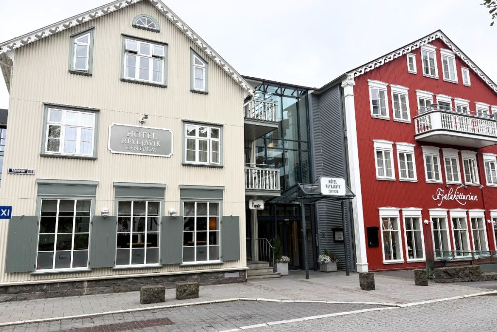 Cream and red facade of Hótel Reykjavík Centrum on a cloudy day