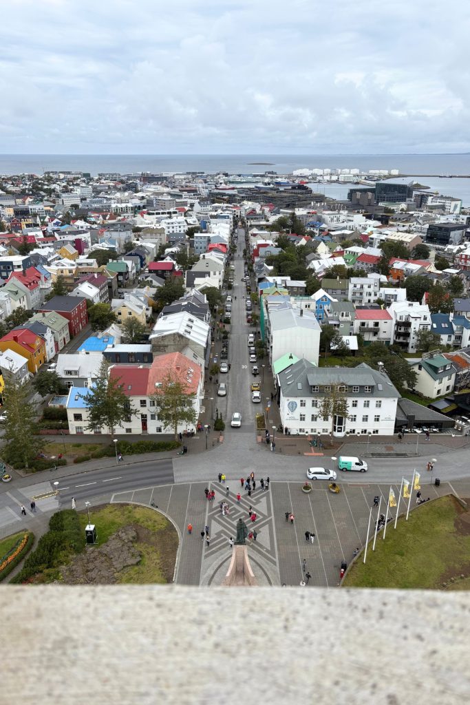 View from the Hallgrímskirkja tower down a street of colorful rooftops toward the harbor