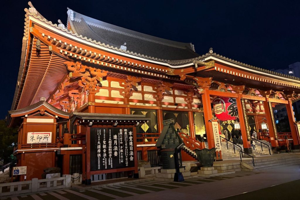 Kannon-do Hall at Senso-ji lit up at night, showing its sloping tiled roof