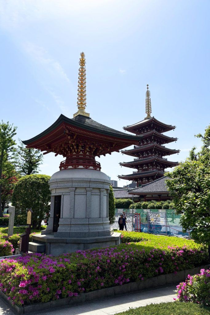 Stone monument and azalea garden with the Five-Storied Pagoda visible in the distance at Senso-ji