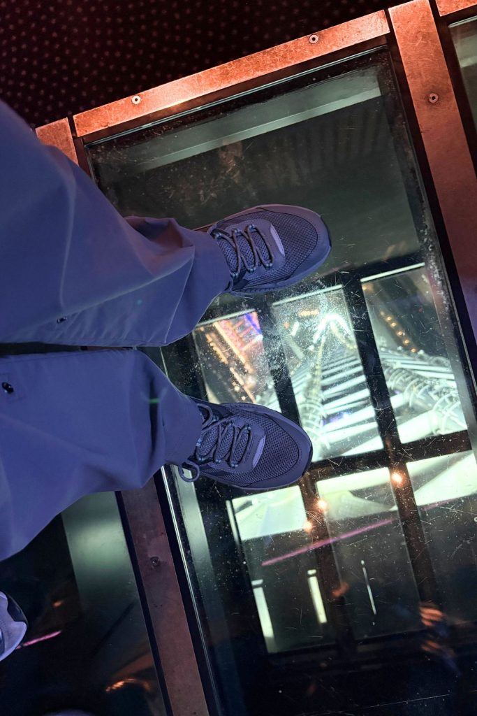 Standing on the glass floor of Tokyo Skytree's Tembo Deck, city lights visible below