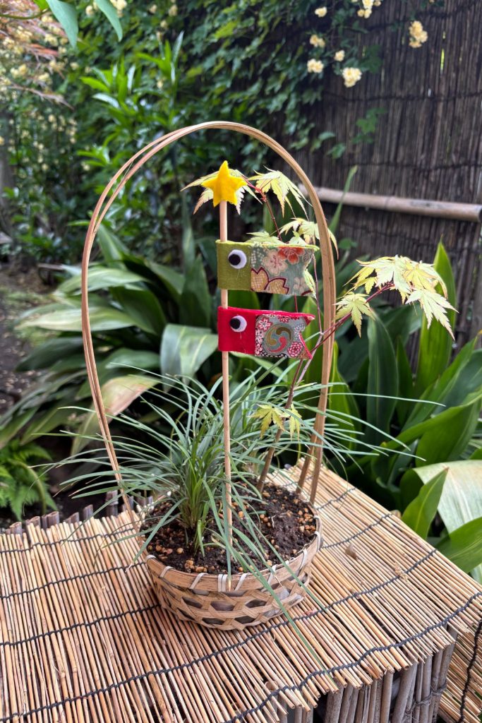Small decorative arrangement of grass and paper ornaments in the peony garden