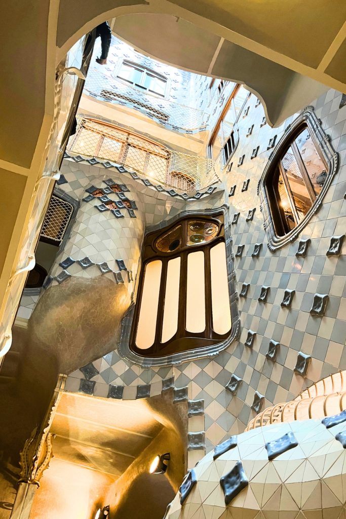 Casa Batlló interior stairwell with tiled walls and skylight