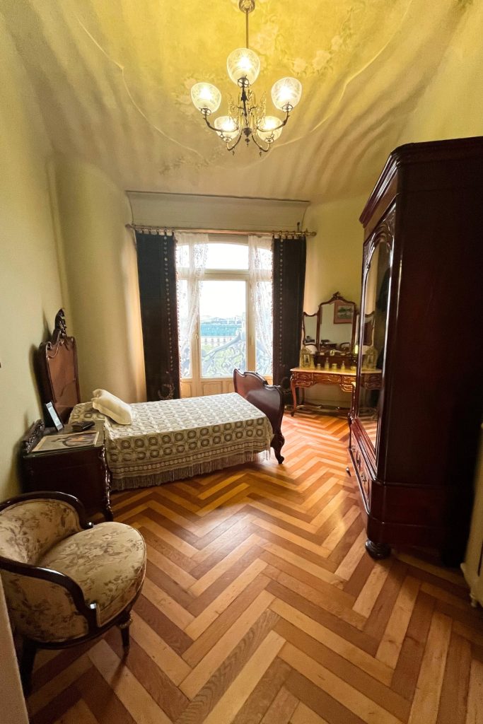 Furnished period bedroom inside Casa Milà apartment in Barcelona
