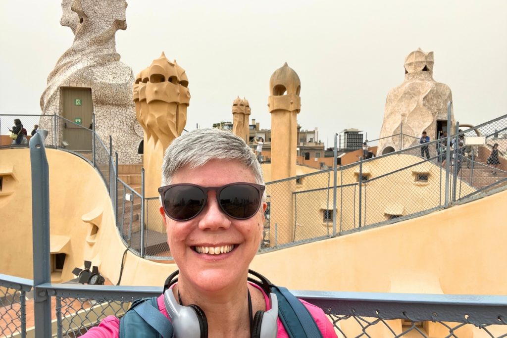 Selfie on Casa Milà rooftop terrace with sculptural chimneys in background