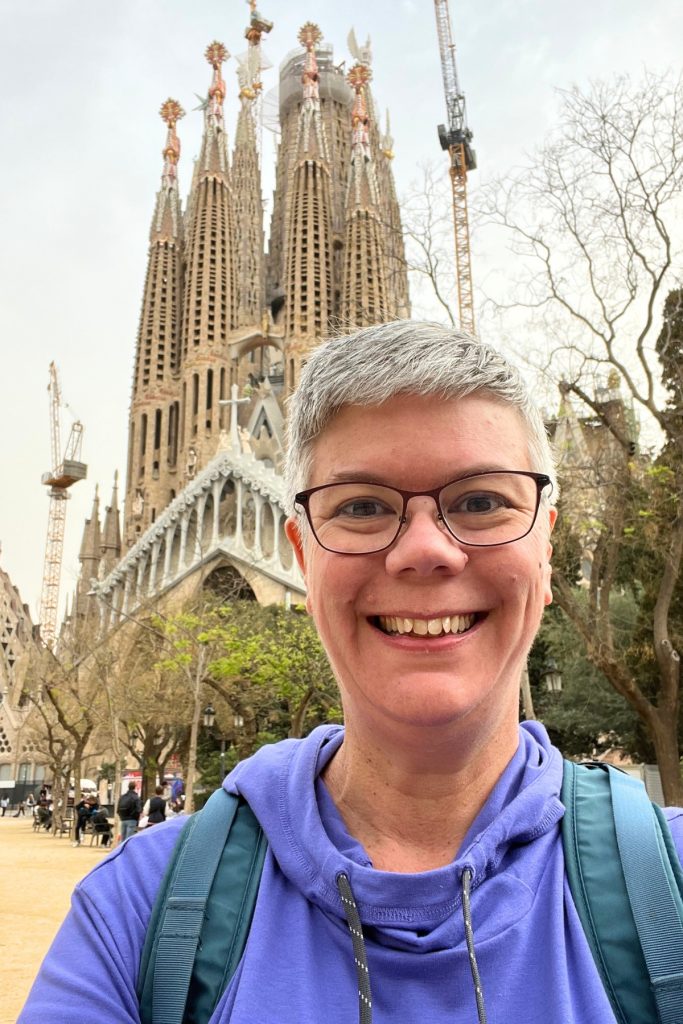Selfie in front of Sagrada Família exterior with towers and construction cranes