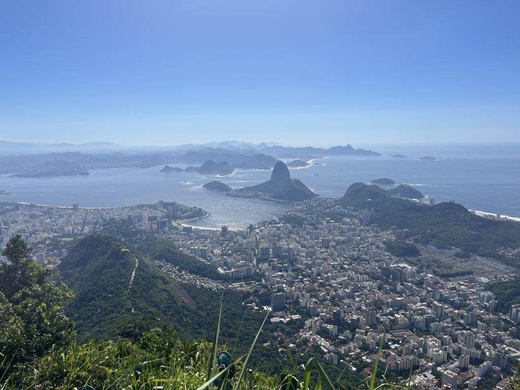 View of Sugarloaf Mountain and the Copacabana Beach curve from the summit of Christ the Redeemer in Rio de Janeiro