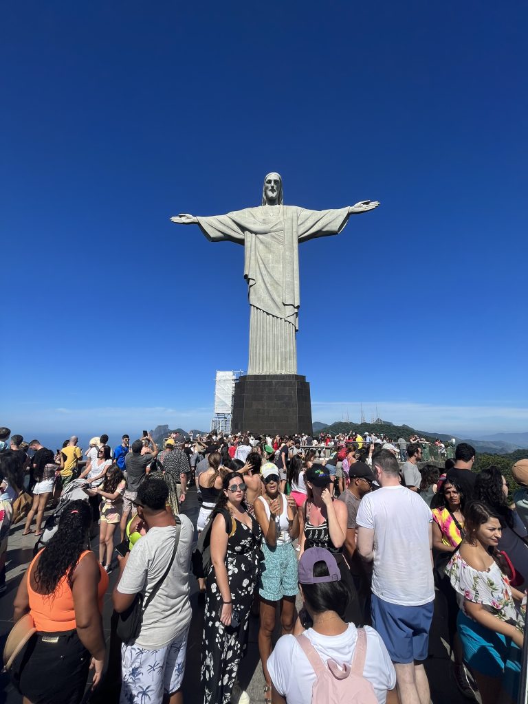 Crowd of tourists gathered at the base of the Christ the Redeemer statue in Rio de Janeiro