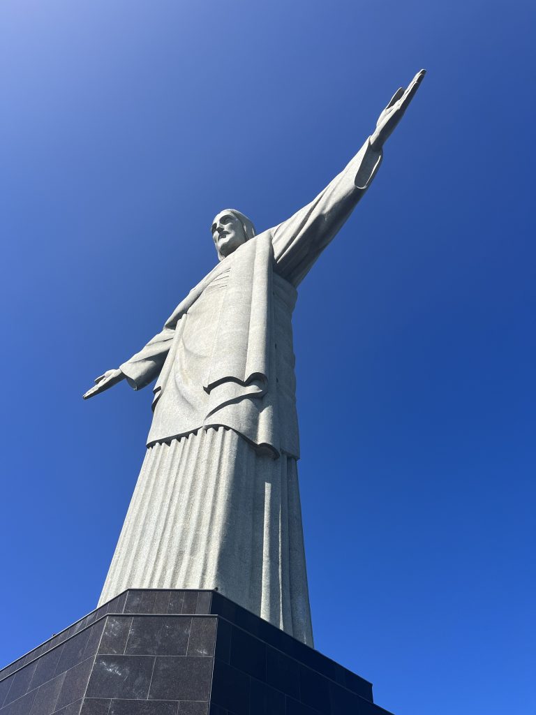 Low-angle view of the Christ the Redeemer statue against a clear blue sky in Rio de Janeiro
