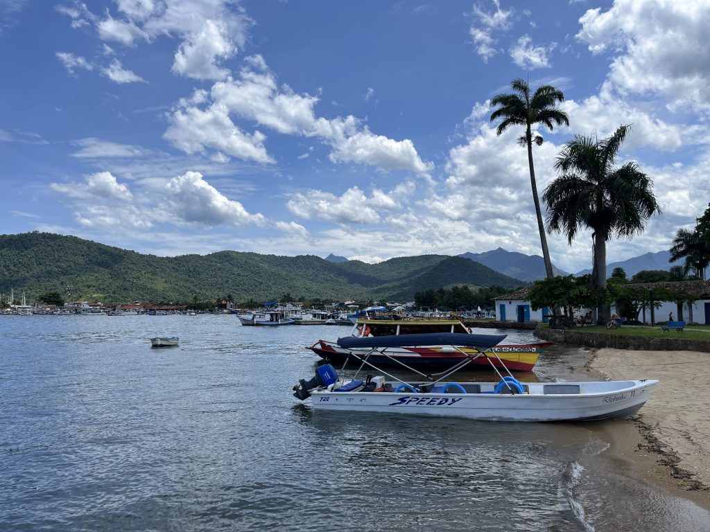 Small boats and beach along the waterfront in Paraty's historic town center