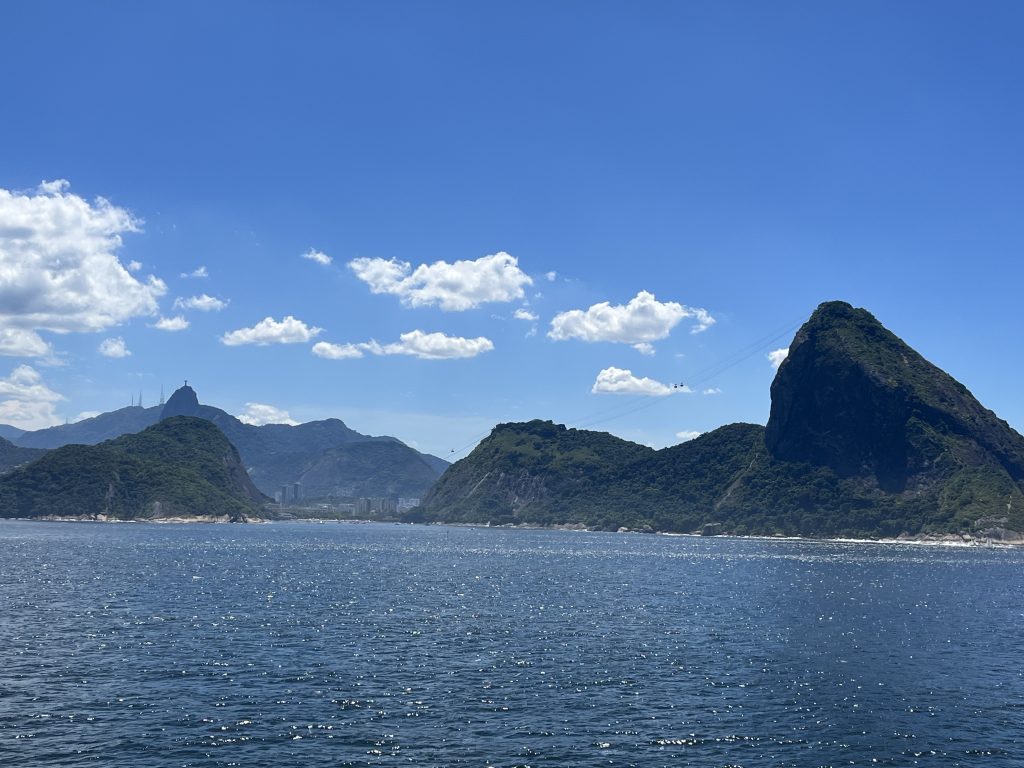 Wide view of Guanabara Bay from a cruise ship with Sugarloaf Mountain and Christ the Redeemer statue visible in Rio de Janeiro