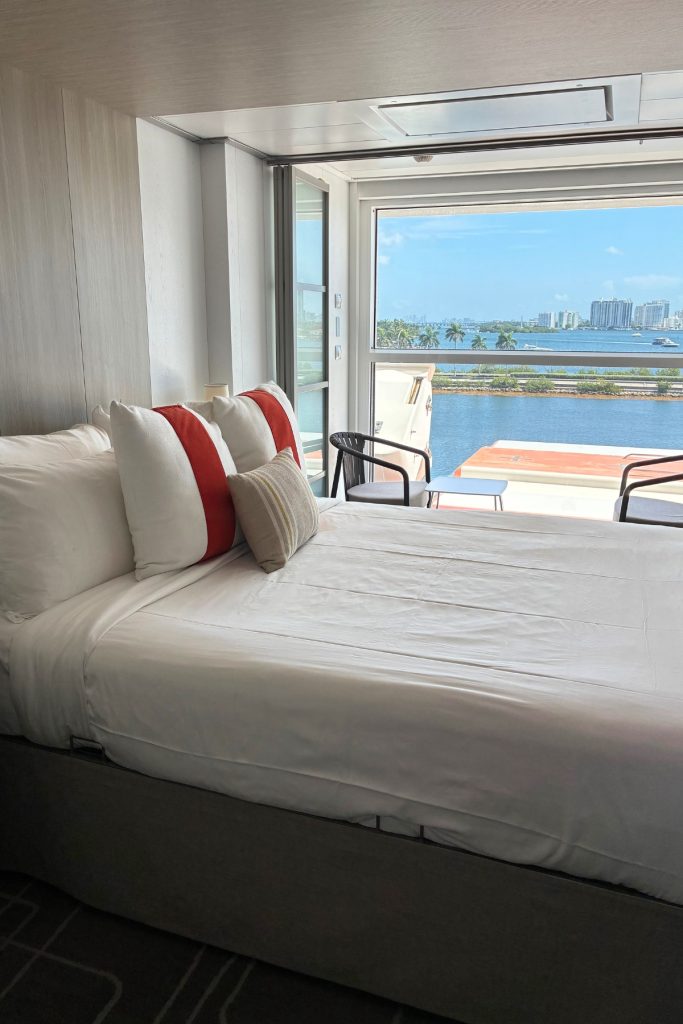Edge Stateroom on Celebrity Beyond with bed facing an open infinite veranda overlooking Miami