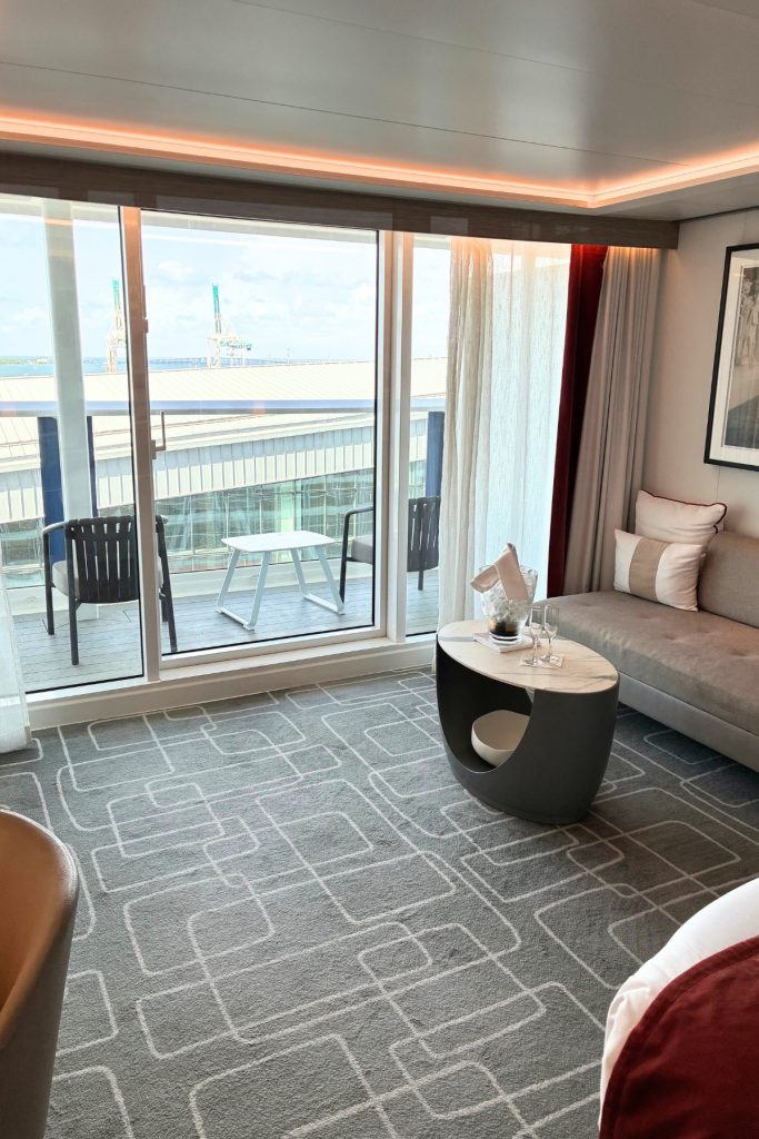 Sky Suite living area on Celebrity Beyond with seating, coffee table, and private balcony