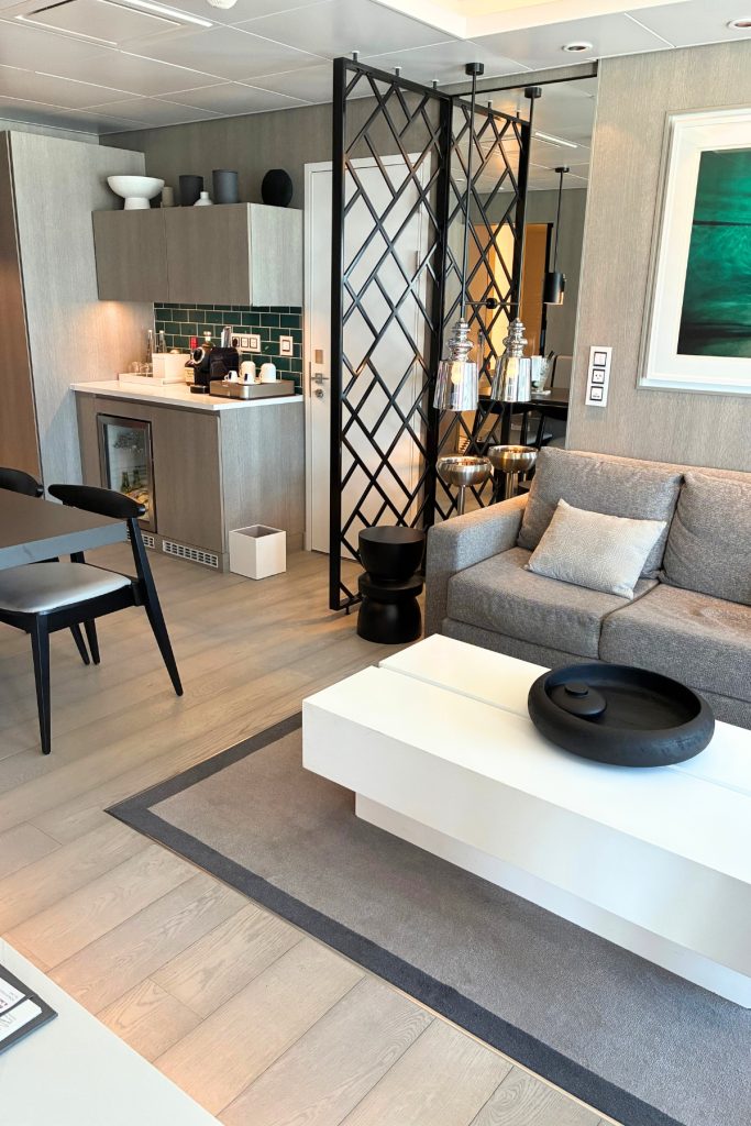 Royal Suite living area on Celebrity Beyond with sofa, dining table, and wet bar