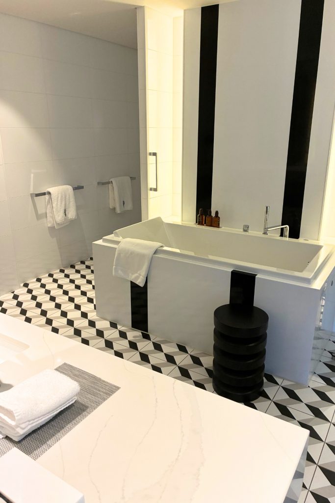 Royal Suite bathroom on Celebrity Beyond with soaking tub and black and white tile floor