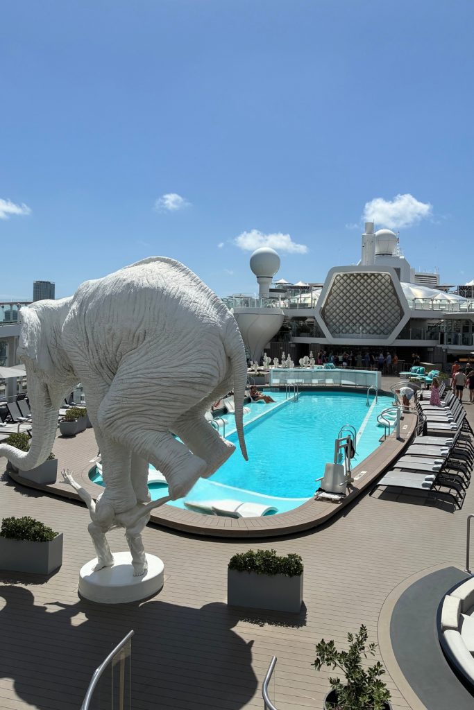 Main pool deck on Celebrity Beyond with elephant sculpture, loungers, and open sky
