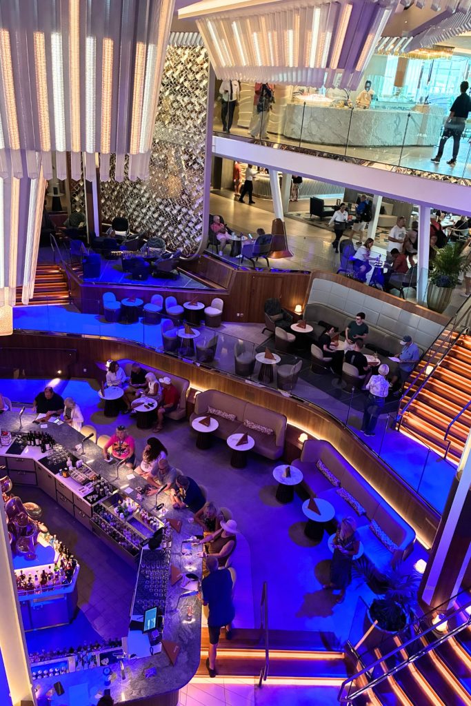 Elevated view of Celebrity Beyond's Grand Plaza atrium with Martini Bar and multiple lounge levels