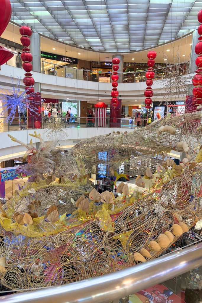 Woven dragon sculpture suspended between two floors of the atrium at Lucky Chinatown Mall in Manila