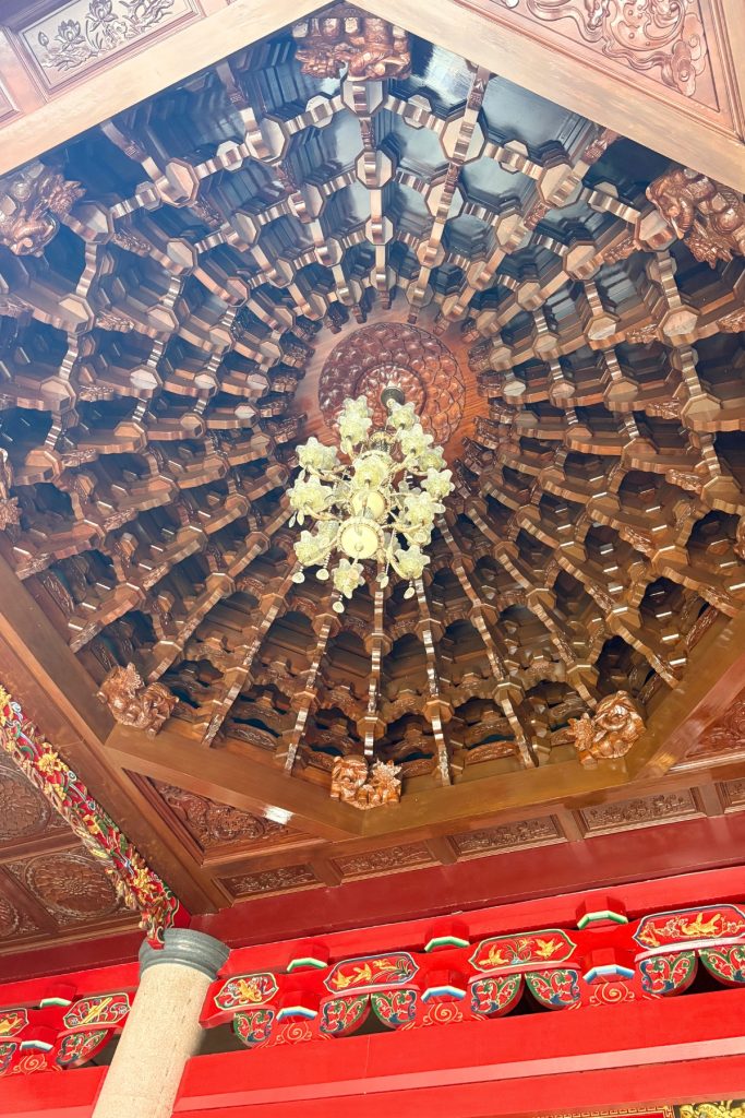 Octagonal wood-paneled ceiling with a hanging chandelier inside Chong Hock Tong temple at Manila Chinese Cemetery
