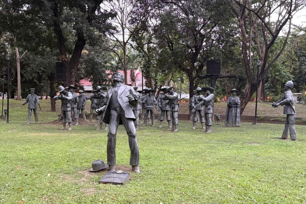 Life-size bronze tableau recreating the execution of Jose Rizal, his back to the firing squad, at Rizal Park in Manila